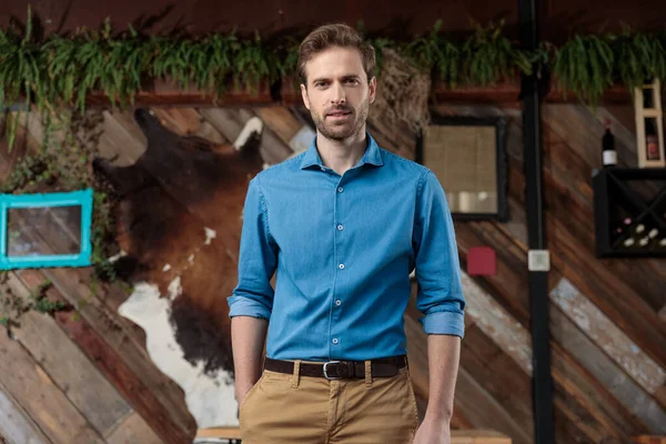 Serious businessman holding his hand in his pocket — Stock Photo, Image