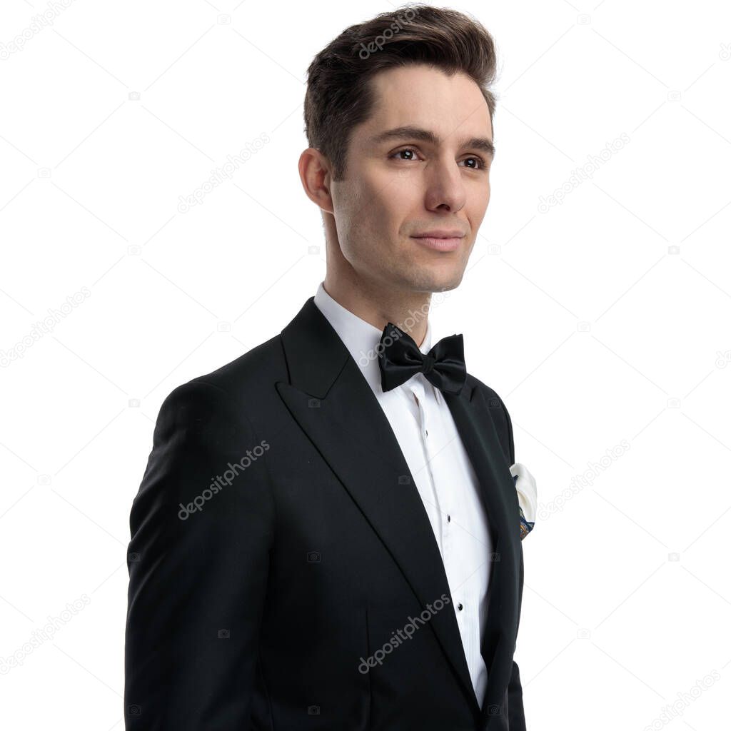 happy young groom looking to side and smiling