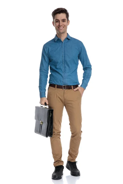Happy young man holding suitcase and smiling — Stock Photo, Image