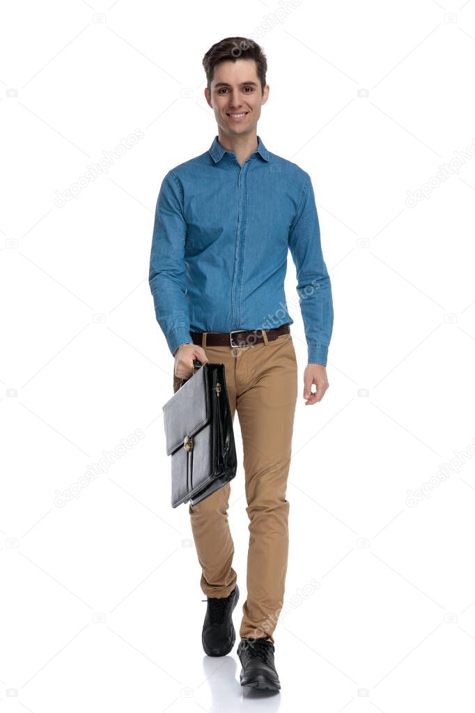 smart casual man smiling and holding suitcase