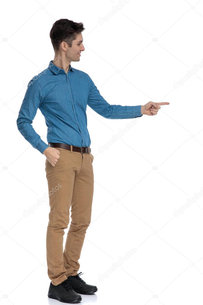 side view of smart casual man smiling and pointing finger