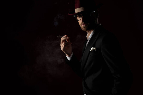 Mysterious fashion model smoking a cigarette 