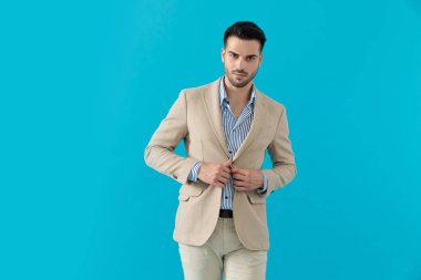 Havalı manken montu ayarlıyor ve gülümsüyor. 