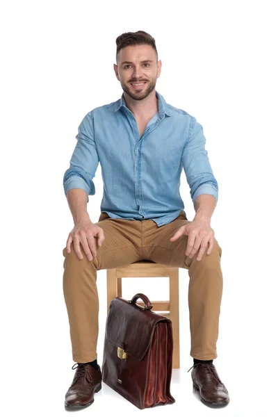 Happy casual man smiling and sitting on white background — 스톡 사진