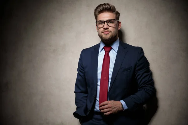 Hombre de negocios de pie con la mano en el bolsillo y mirando la cámara — Foto de Stock