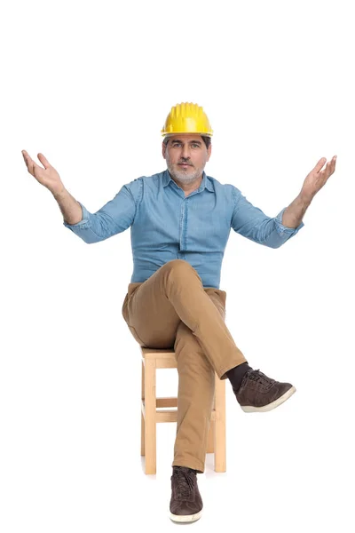 Zelfverzekerde casual man begroeten en het dragen van een bouwhelm — Stockfoto