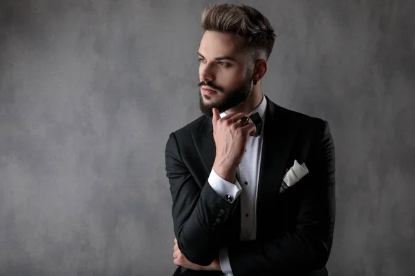 Businessman sitting with hands folded and looking aside pensive — 图库照片