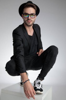 cool young guy wearing hat and sunglasses