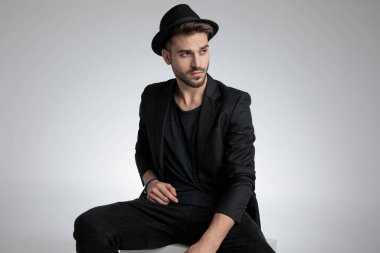 dramatic cool guy wearing black coat and hat