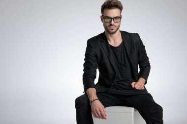 dramatic cool guy wearing black coat and sunglasses