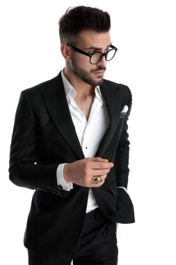 businessman preparing to grab something from pocket cautious