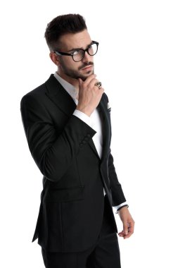 businessman standing and touching chin pensive
