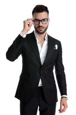businessman standing and fixing eyeglasses
