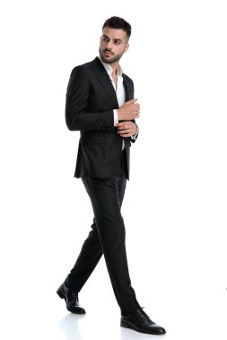 businessman walking one way and looking the other