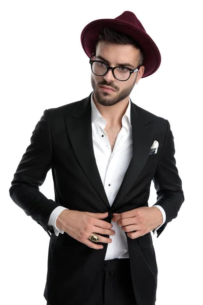 Business man fixing jacket while looking away pensive — Stock Photo, Image