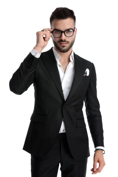 Businessman standing and fixing eyeglasses — 스톡 사진