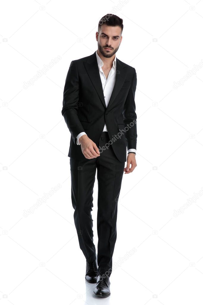 businessman walking with confidence and staring at camera