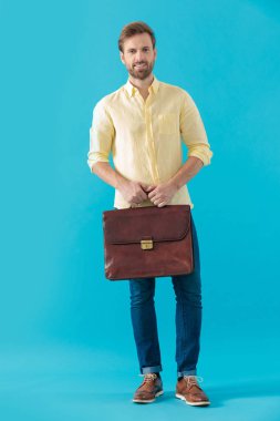 Confident casual man smiling and holding a briefcase