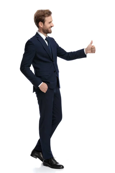 Happy businessman smiling and making thumbs up sign — Stock Photo, Image