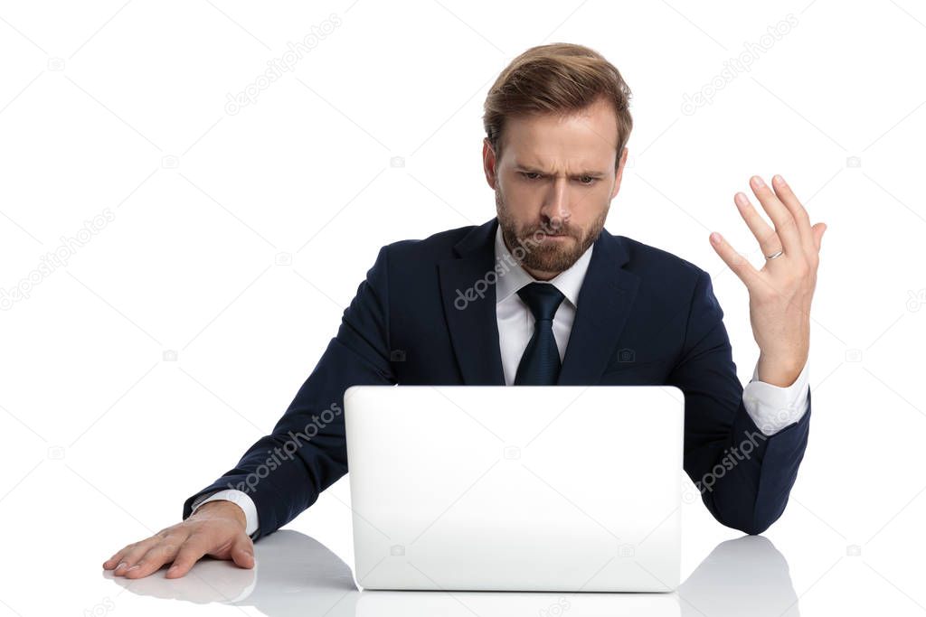 mad businessman in navy blue suit reading emails