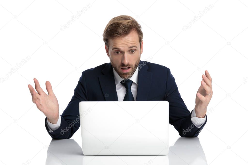 shocked young businessman in navy blue suit reading emails