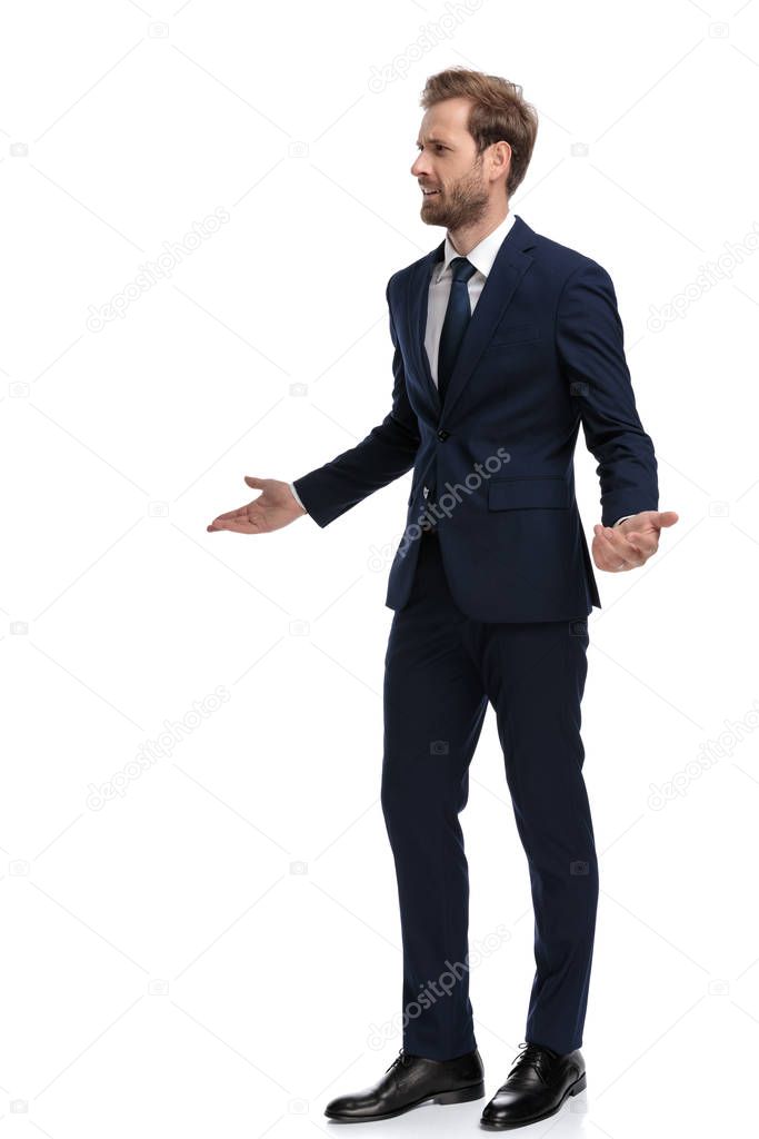 young businessman in navy blue suit asking for explanations