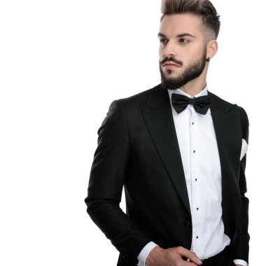 businessman standing with hand in pocket looking aside with clas