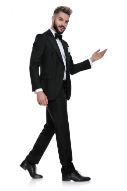  young businessman walking while presenting something