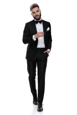 businessman walking with hand in pocket looking away seductive 