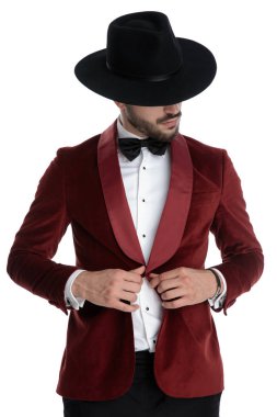 mysterious young elegant model adjusting coat