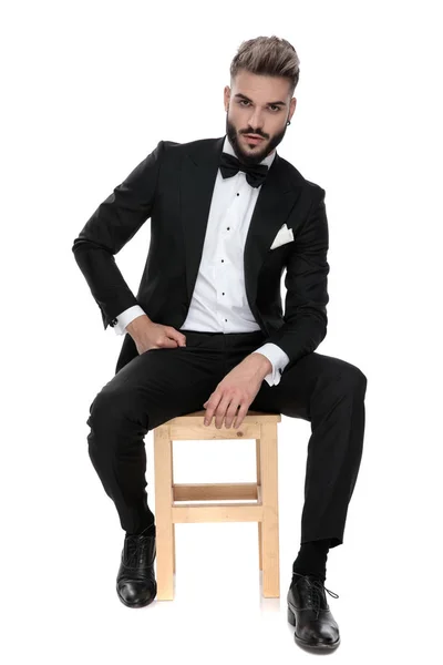 Businessman sitting with hands resting on lap serious — Stok fotoğraf