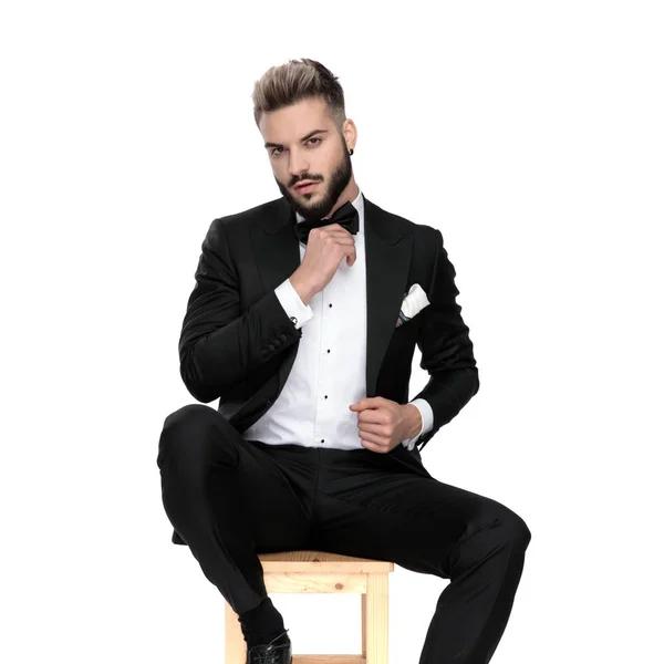 Hombre de negocios sentado y fijación chaqueta y corbata — Foto de Stock