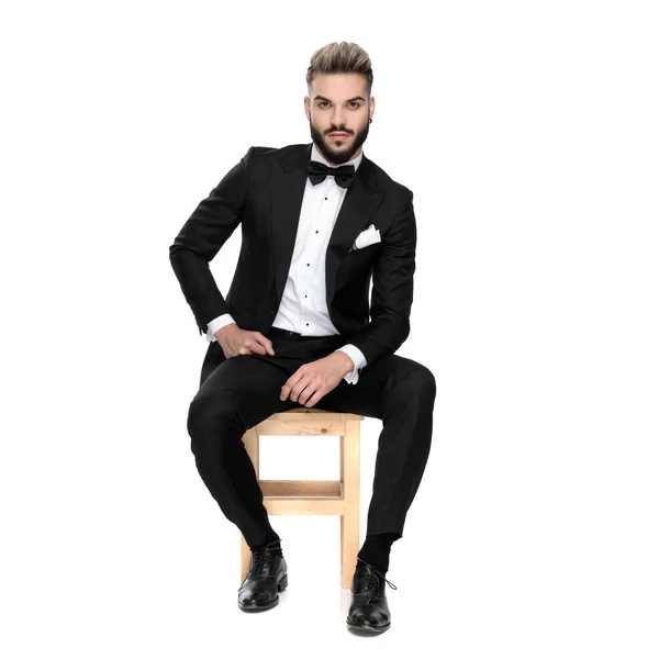Businessman sitting and posing relaxed with hands resting on lap — Stok fotoğraf