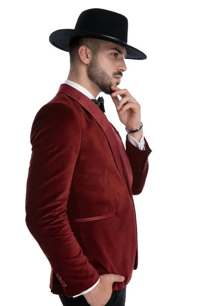 Thoughtful young model in red velvet tuxedo thinking — Stock Photo, Image