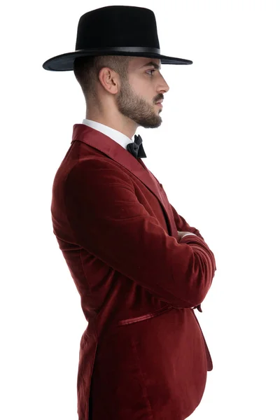 Sexy young man in red velvet tuxedo crossing arms — Stok fotoğraf