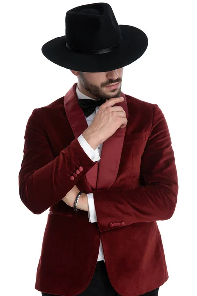 Thoughtful fashion model in red velvet tuxedo thinking — 图库照片