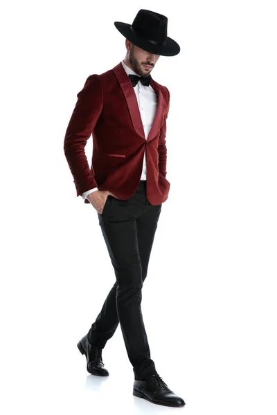 Dramatic fashion model in red velvet tuxedo walking — 图库照片