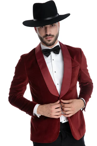 Sexy young model in red velvet tuxedo adjusting coat — 스톡 사진