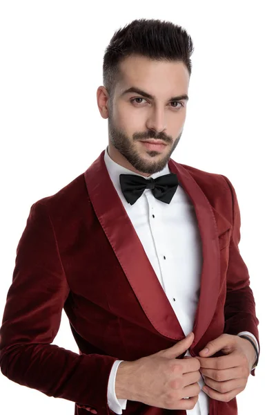 Young fashion model in red velvet tuxedo adjusting coat — Stok fotoğraf