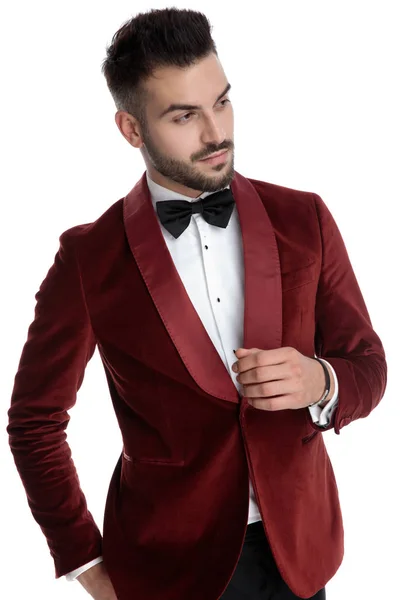 Confident young model in red velvet tuxedo looking to side — Stockfoto