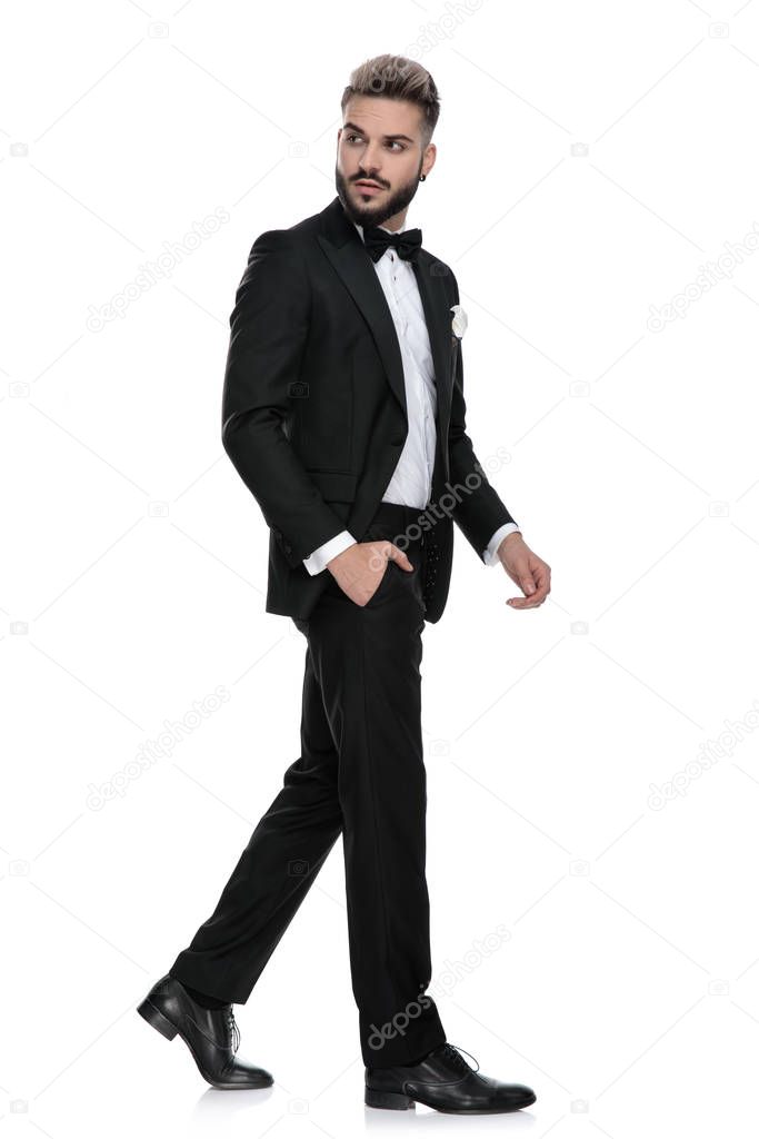 businessman walking one way while looking the other way cool