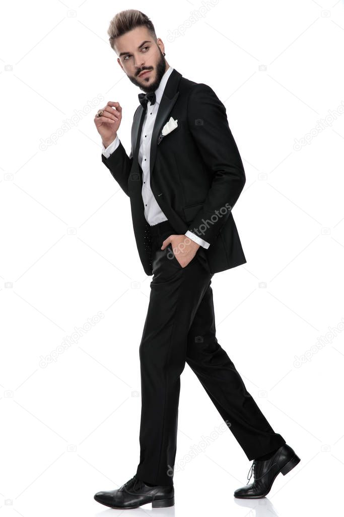 businessman walking with hand in pocket and the other folded