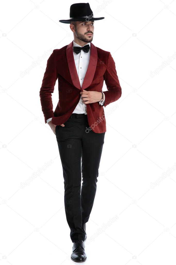 elegant young model in red velvet tuxedo walking
