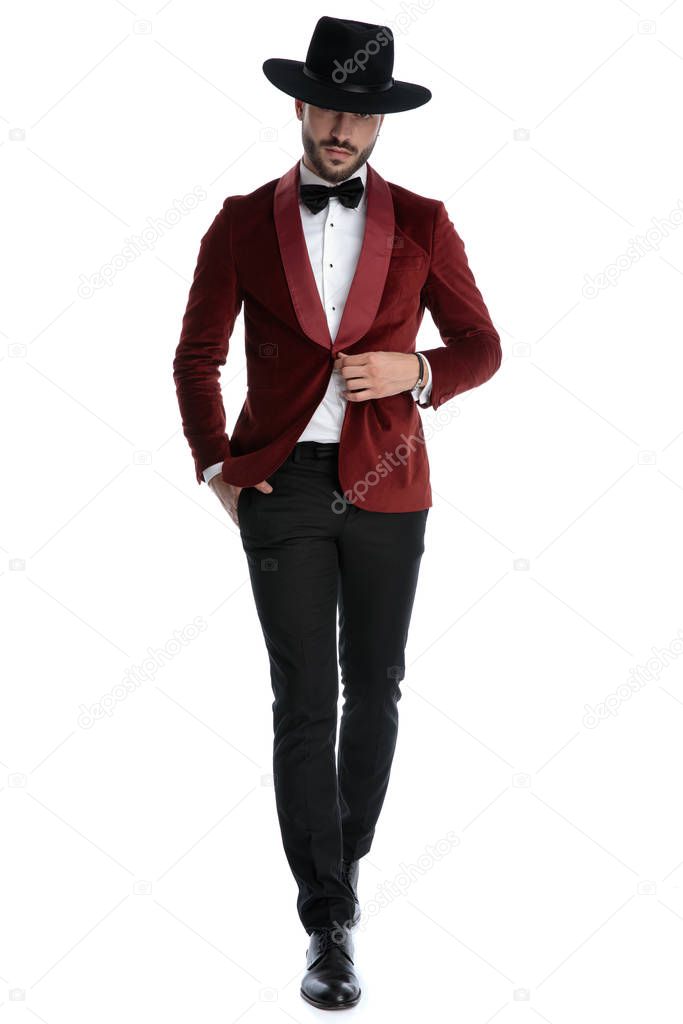 sexy young model in red velvet tuxedo fixing coat