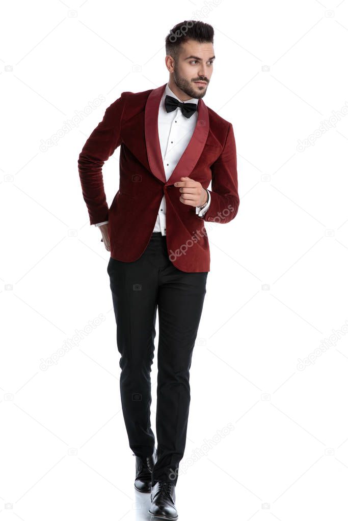 sexy young model in red velvet tuxedo walking and looking to sid