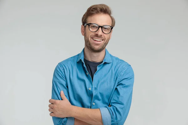 Opgewonden jonge casual man lachen en kruisen armen — Stockfoto