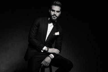 İş adamı serin poz verirken oturup ellerini dinlendiriyor