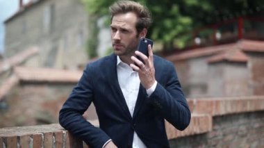 Mutlu genç işadamı telefonuna coşku ve heyecanla cevap veriyor.