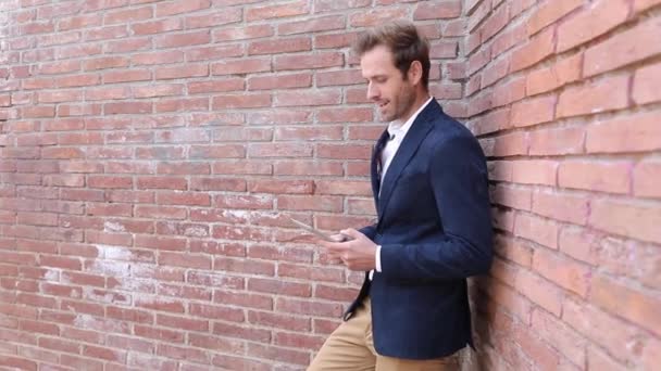 Young smiling man working on  his tablet pad computer — Stock Video