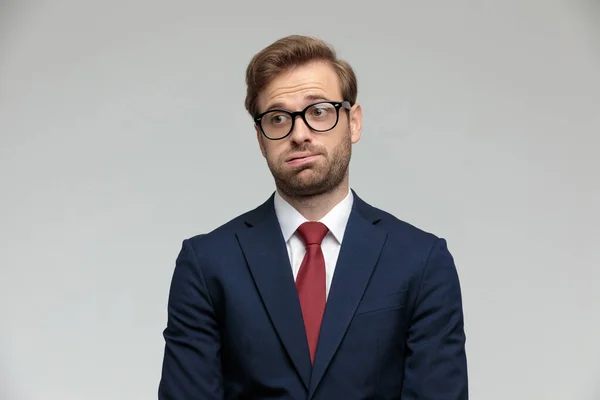 Businessman standing and holding air in his mouth anxious — Stockfoto